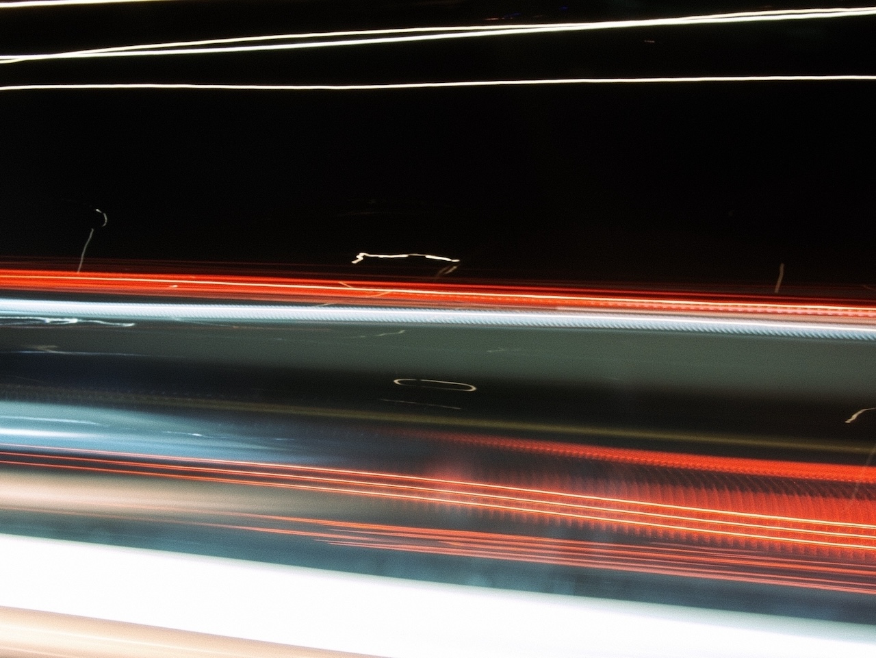 Red and white light trails of traffic.