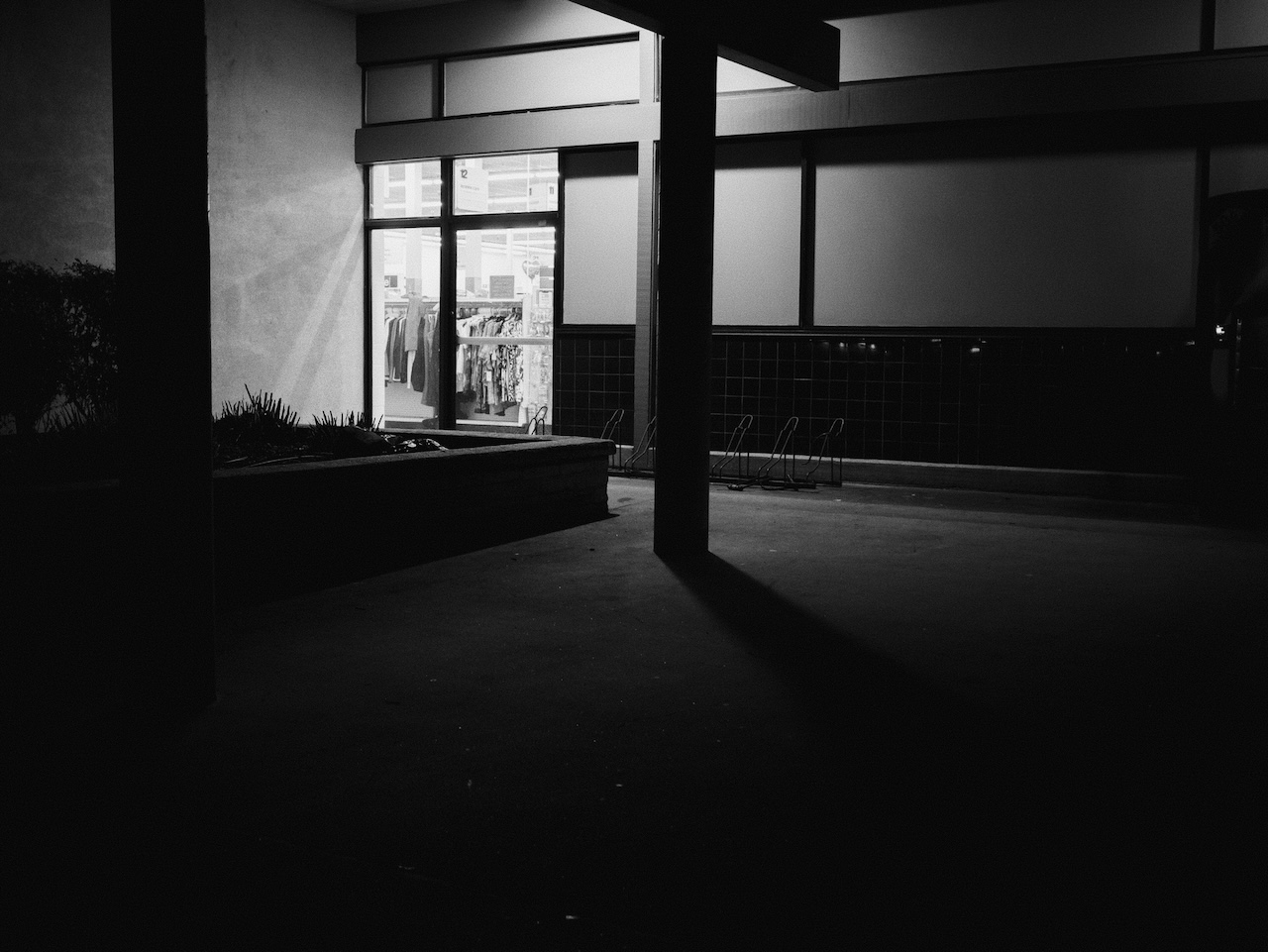 Black and white photograph outside a CVS at night.